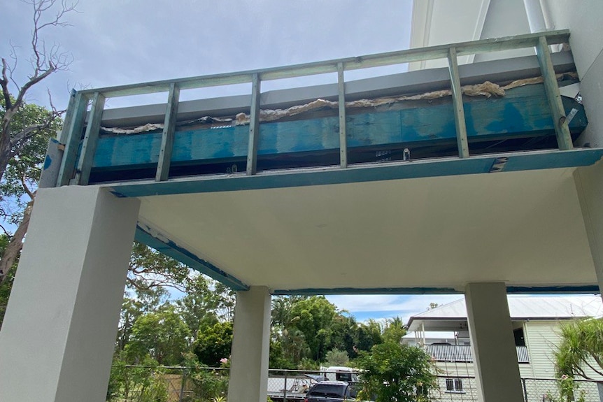 a picture taken from the ground of unfinished cladding on a new partially built home