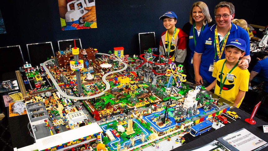 The Krog family is standing with a replica of Legoland in Denmark.