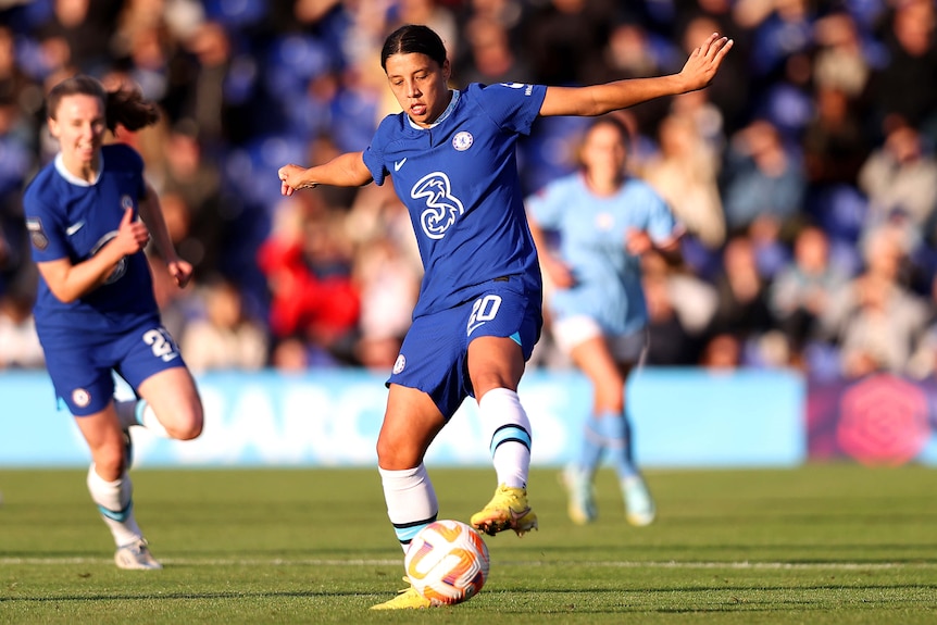 Sam Kerr controls the ball with her foot as a team mates looks on in the background