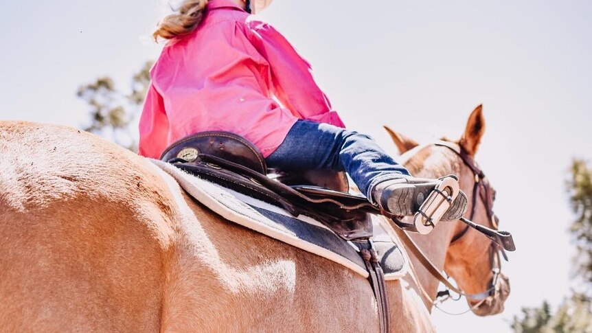 A photo of a very small girl riding a horse.