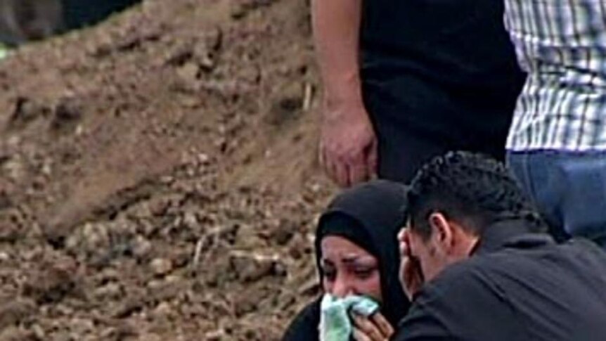 Mourners grieve at a funeral for one of the Christmas Island boat tragedy victims