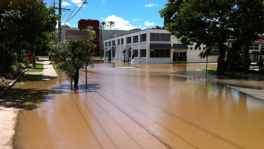 Floodwater pools over a road at Milton in Brisbane, January 29, 2012.