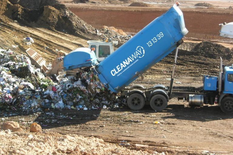 Waste truck tips dumps rubbish at Central Coast landfill site.  