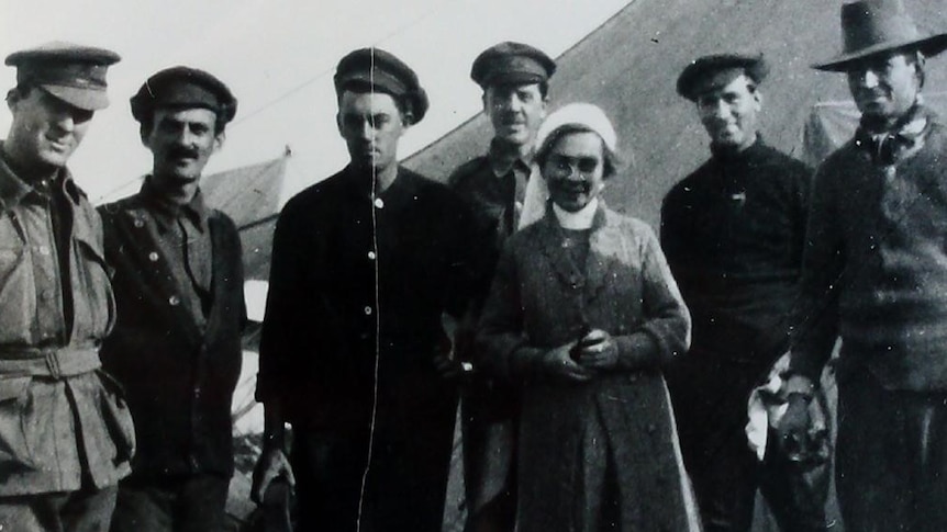 Anne Donnell pictured with Australian troops in National Library of Australia photo