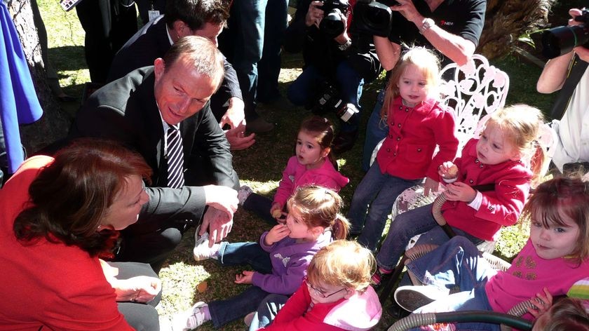 Tony Abbott talks to children at a nursery school in Brisbane.