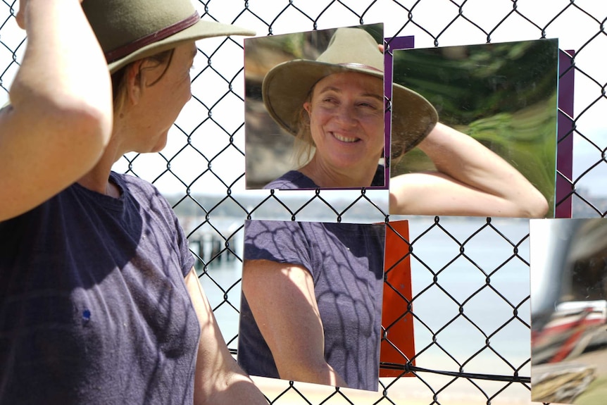 Lucy Barker reflected in mirrors from her sculpture