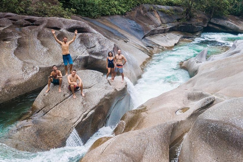 A group of people next to a raging current