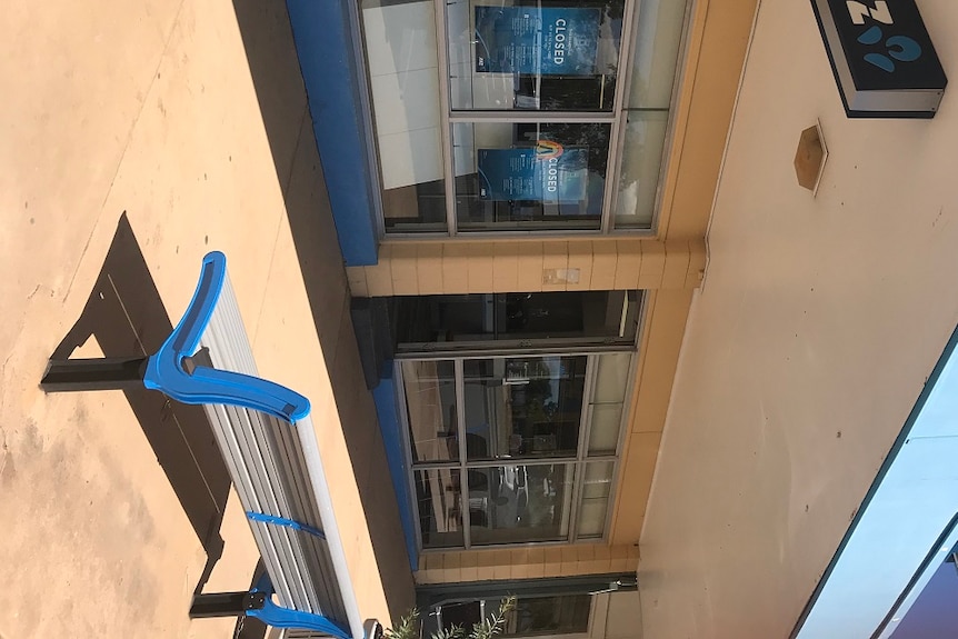 ANZ Bank cream and blue shopfront in Moura with closed signs on the window