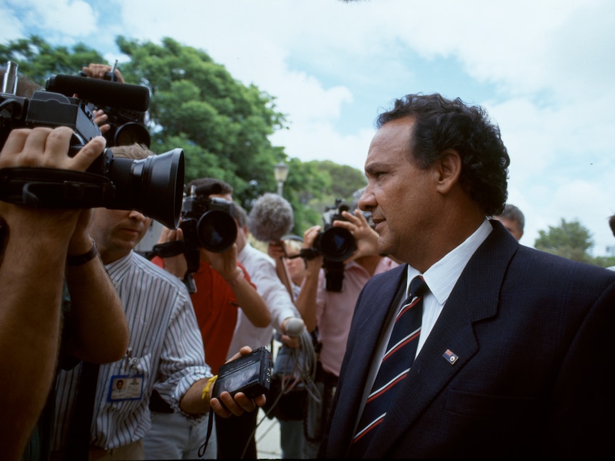 Labor Minister Ernie Bridge responds to questions from reporters outside WA State Parliament in 1990.