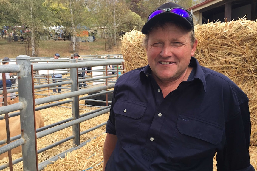 Dairy farmer Royston Nettleton sitting on a hay bale.