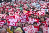 Thousands of South Koreans holding