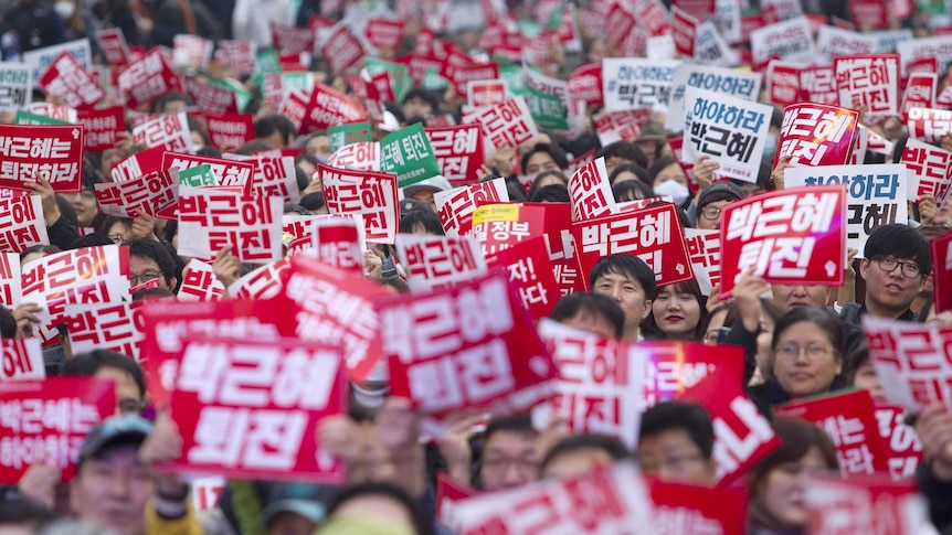 Thousands of South Koreans holding