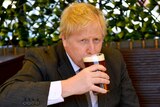 Boris Johnson sips a pint in the beer garden.