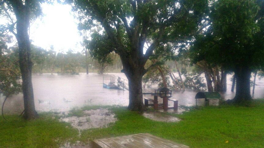 A lake flooding, boat in foreground.