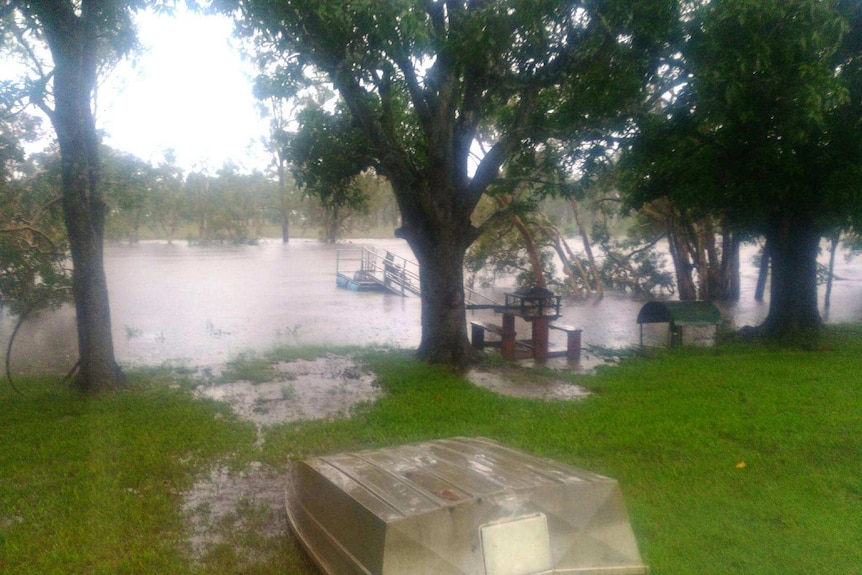 A lake flooding, boat in foreground.