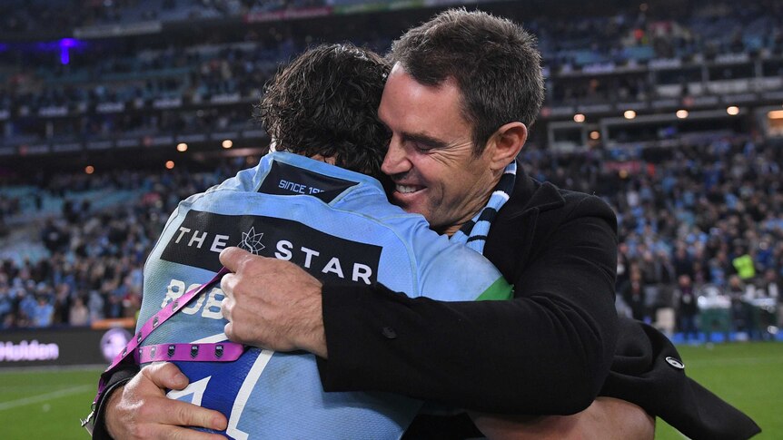 Blues coach Brad Fittler (R) hugs James Roberts after winning State of Origin II in Sydney.