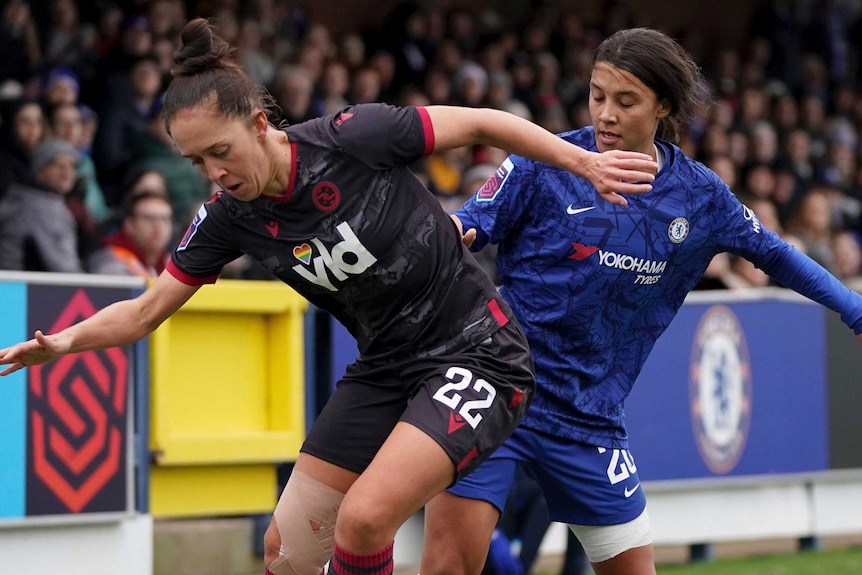 Sam Kerr challenges Jo Potter near the sideline in their WSL match in London