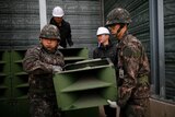 South Korean soldiers dismantle loudspeakers set up for propaganda broadcasts near the demilitarized zone.
