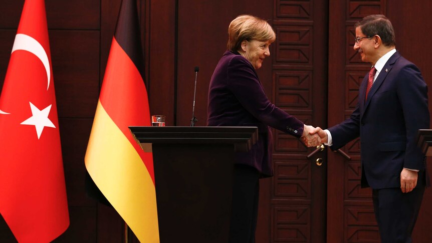 German Chancellor Angela Merkel shakes hands with Turkish Prime Minister Ahmet Davutoglu.
