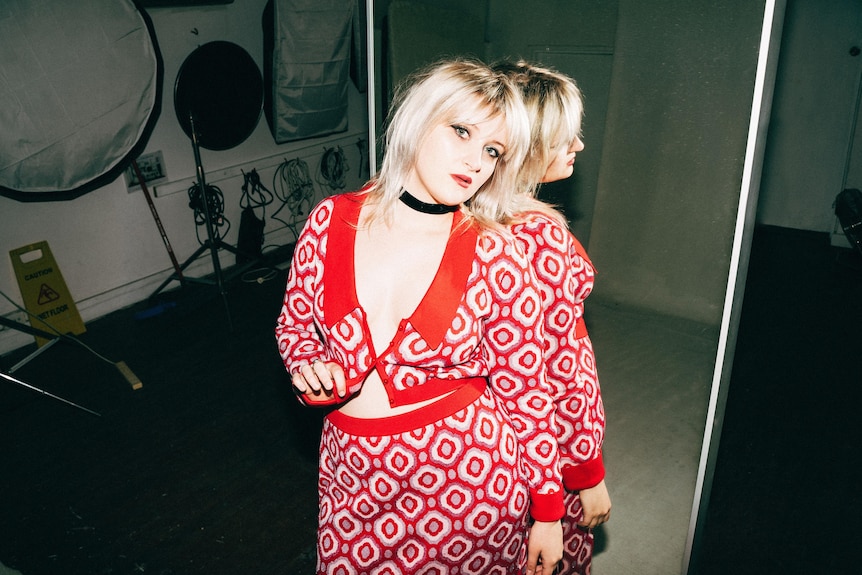 promotional shot of Siobhan Cotchin in a red skirt and top