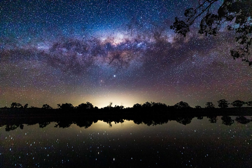 The stars over a body of water.