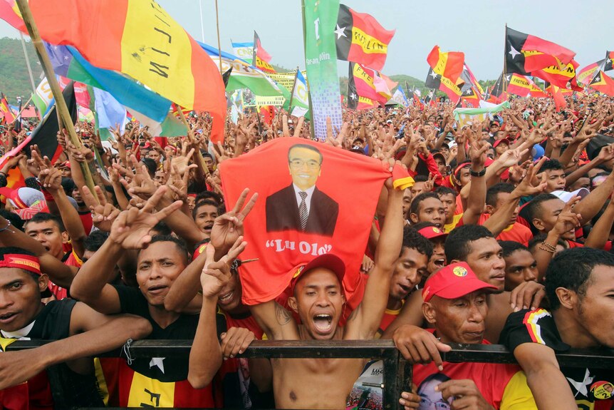 Supporters of presidential candidate "Lu'Olo" cheer at a campaign rally ahead of the election.