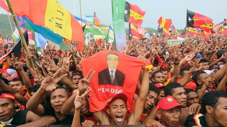 Supporters of presidential candidate "Lu'Olo" cheer at a campaign rally ahead of the election.