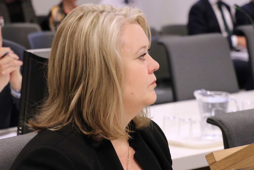 A side-on close-up shot of Kate Ellson seated during a hearing for the inquiry into the City of Perth.