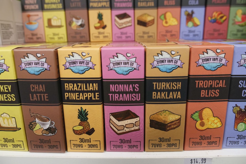 Colourful boxes containing vape flavours sit on a shop shelf.