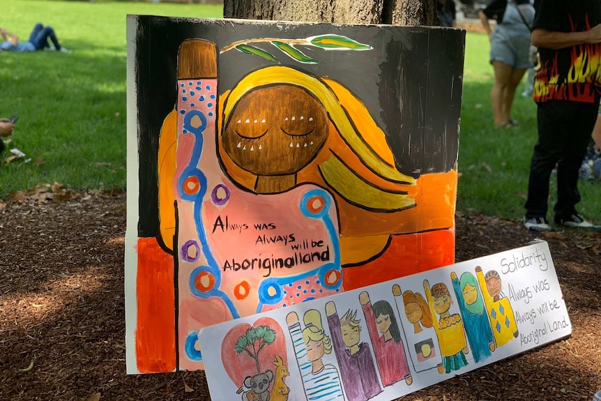 Posters urging a more inclusive Australia Day at an Invasion Day protest rally.