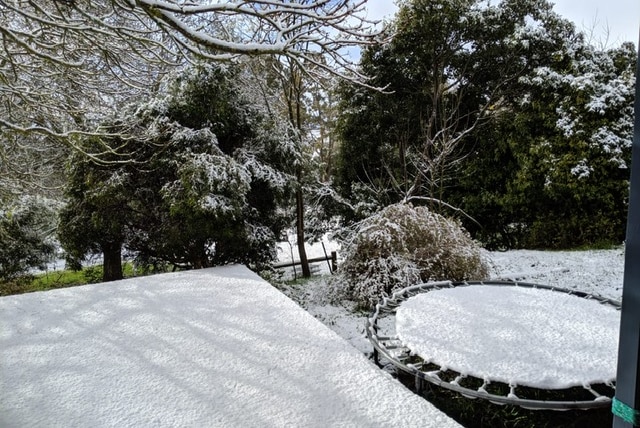 Snow covering a back verandah and trampoline in Mount Macedon.