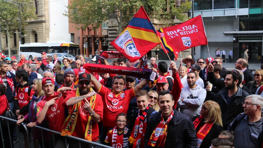 A crowd gathers outside Adelaide Town Hall to greet Adelaide United players.