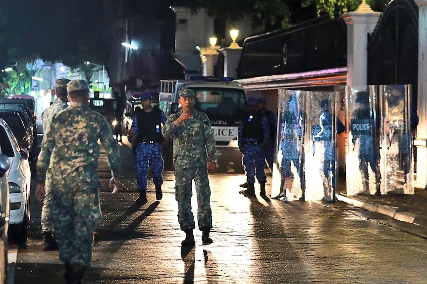 Maldives soldiers walk along a street in Male.