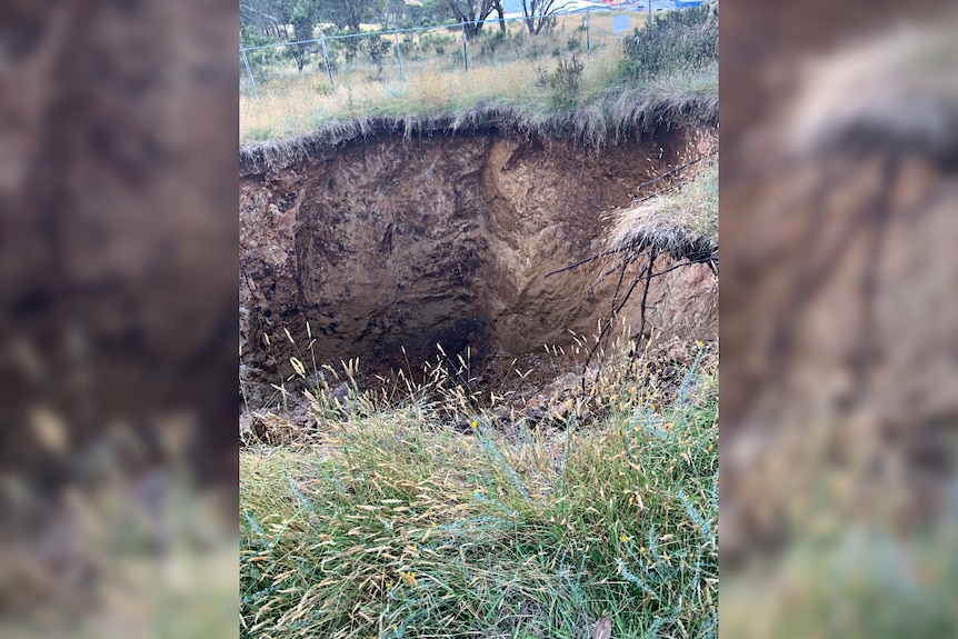 A large sinkhole in the ground.