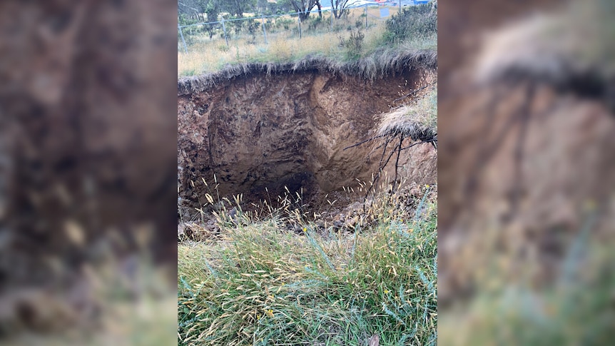 A large sinkhole in the ground.