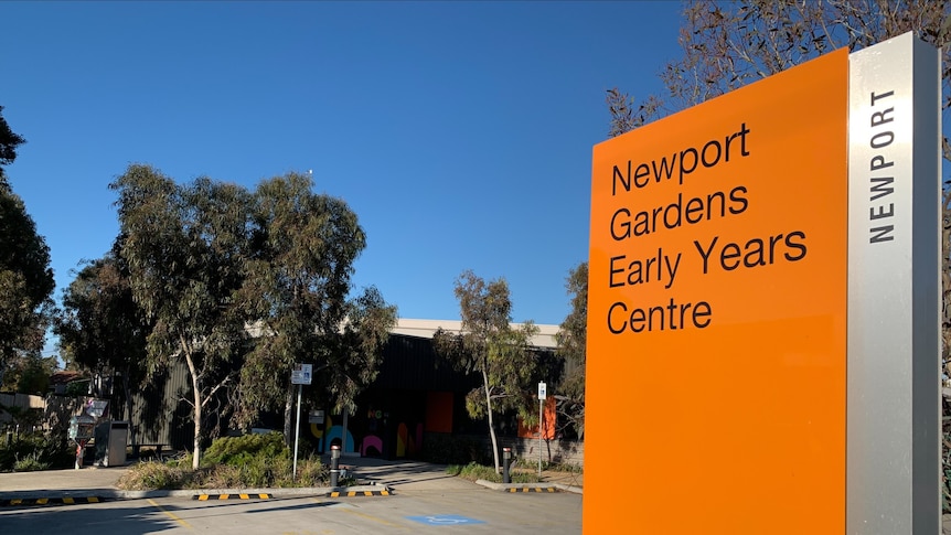 An orange sign showing the entrance to a pre school
