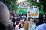 A rally with someone holding up a big sign saying 'Justice for Cleveland Dodd'