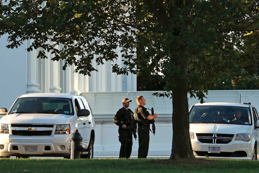 Members of the Secret Service keep watch near the North Portico entrance to the White House.