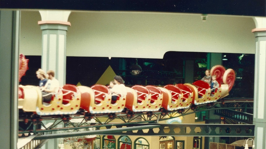 Six people riding on the Brisbane Myer Centre dragon coaster
