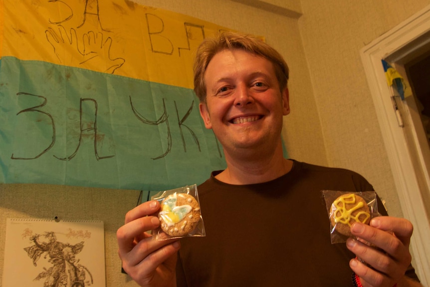 Artem Velichko holds up two biscuits.