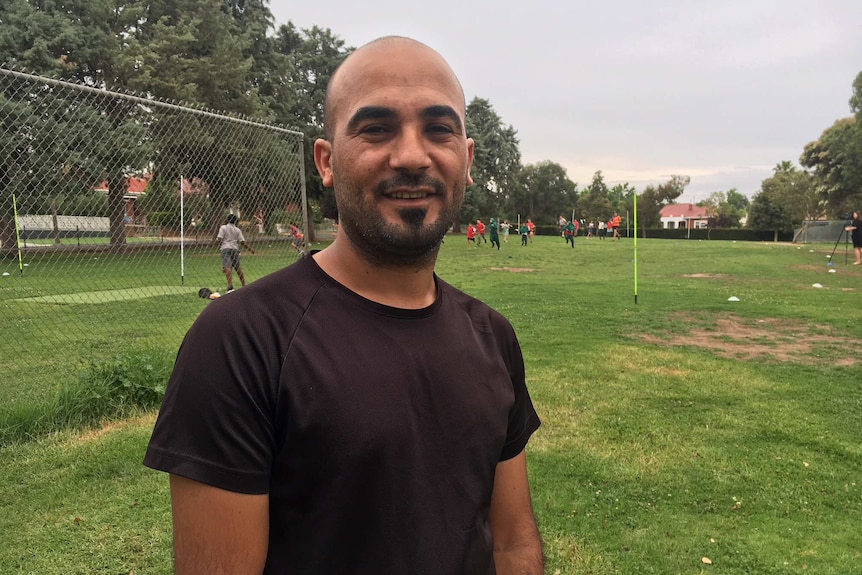 Ismail Darwish from Iraq is happy his children are learning to play Aussie Rules Football in Wagga Wagga