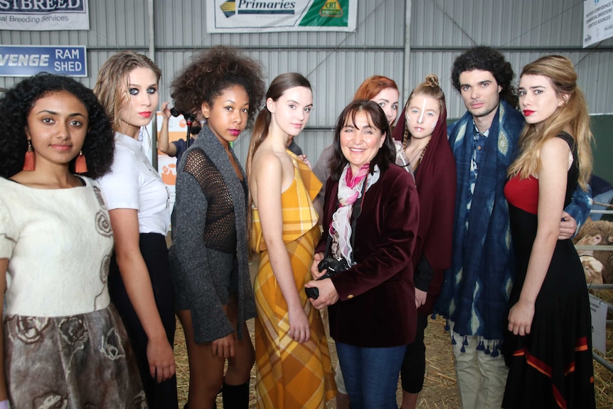 Eco Fashion Week Australia founder Zuhal Kuvan-Mills standing with models.