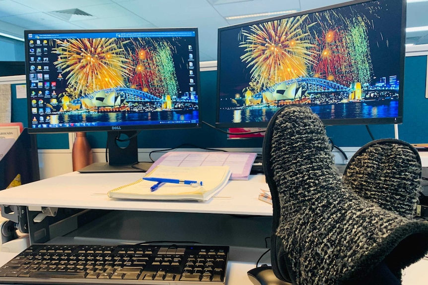 Person wearing slippers at a work desk