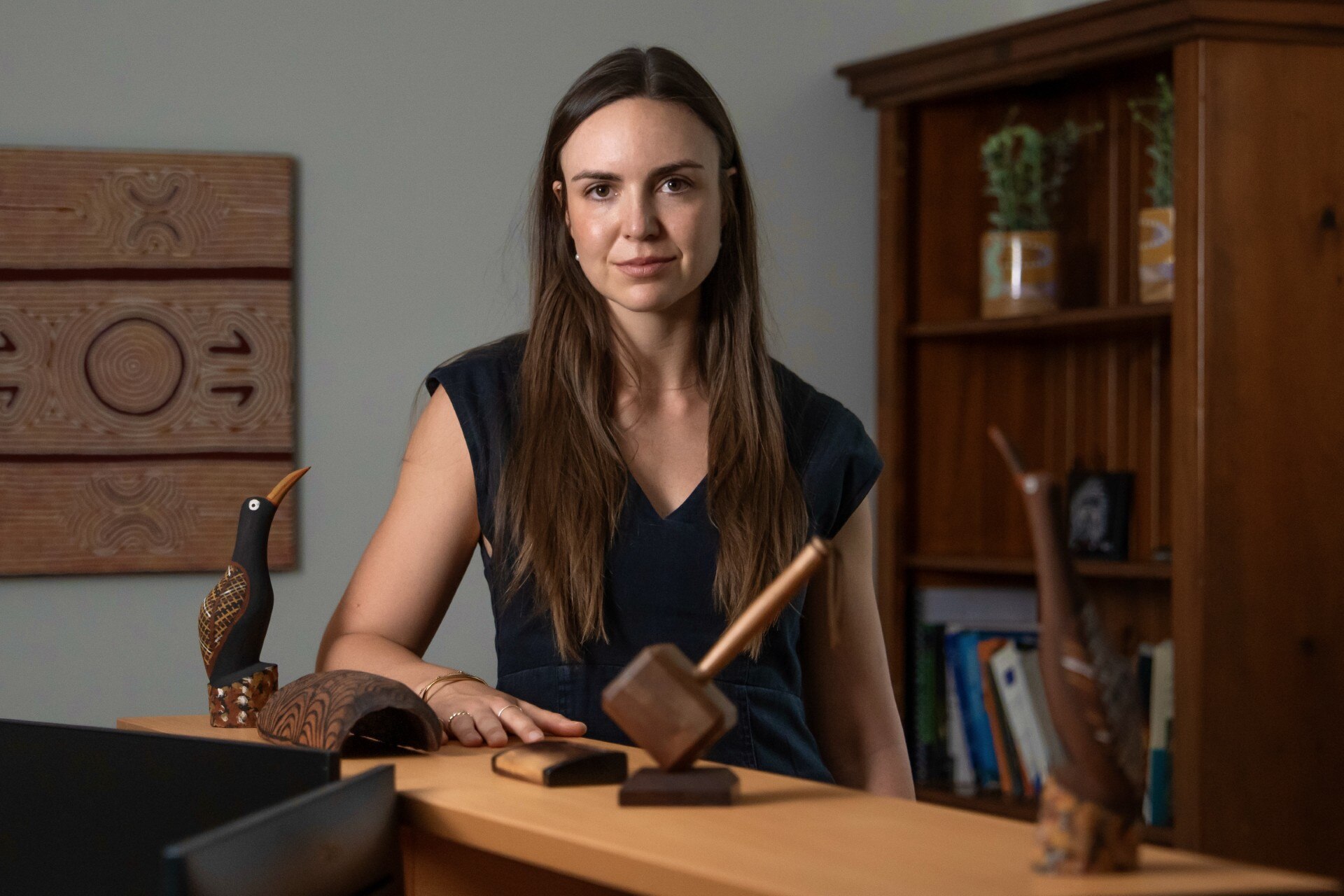 a young woman with long brown hair in an office