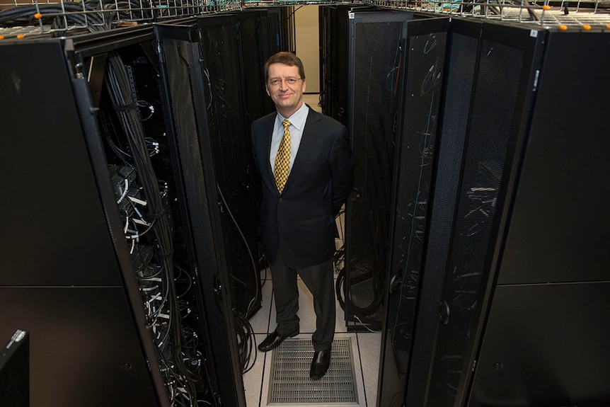 Tuomas Sandholm stands next to the Pittsburgh Supercomputing Centre's Bridges computer.