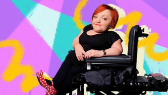 Stella Young smiling in her wheelchair