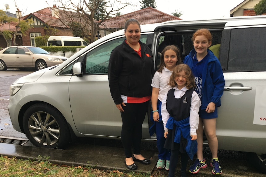 A woman and three schoolgirls