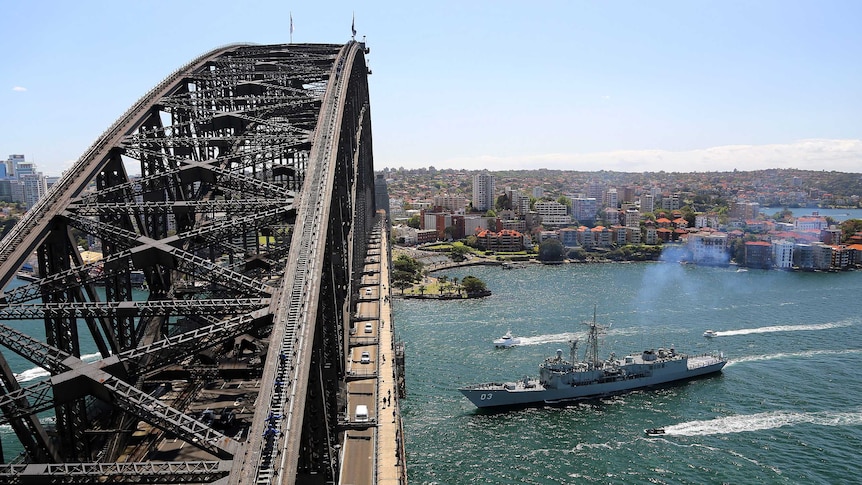 HMAS Sydney heads under the Sydney Harbour Bridge