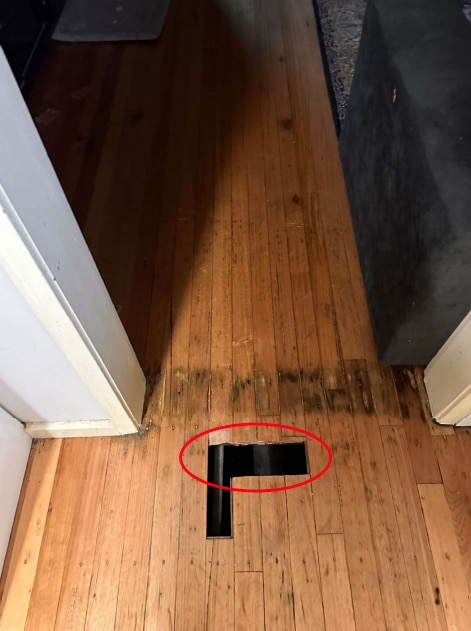 Floorboards with parts cut out of them.