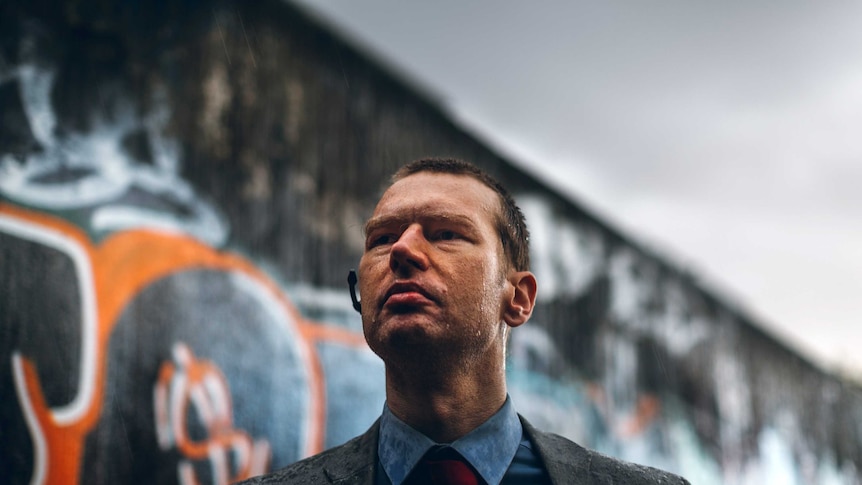 Christopher Anderson standing in an alley in the rain